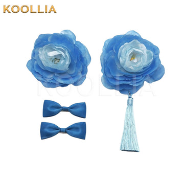 A set of blue floral hair accessories, including two large layered fabric peony blossoms—one with a hanging light blue tassel—and two matching small blue bow hair clips on a white background.