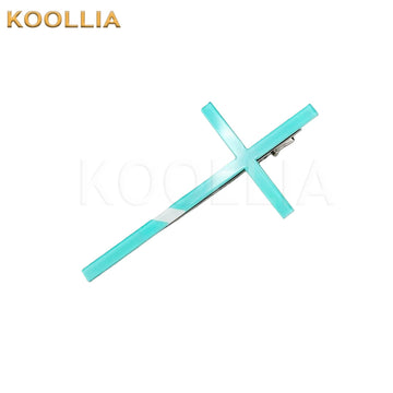 A light mint green translucent acrylic hair clip shaped like a large stylized cross, mounted on a silver metal alligator clasp.