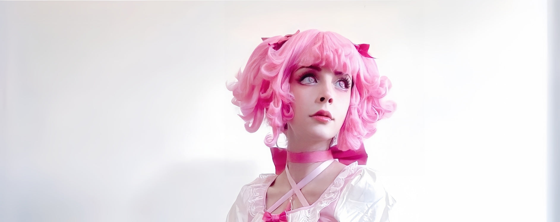 "High-quality Madoka Kaname cosplay costume by Koollia, featuring the iconic magical girl pink and white dress, matching choker, and styled pink wig against a bright clean background."