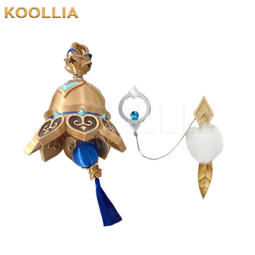 Genshin Impact Tulaytullah's Remembrance cosplay prop display, showing the main golden bell weapon alongside its chain-connected accessories. The prop features a detailed bronze-gold bell with a blue striped centerpiece, a dark blue tassel, and an attached silver ring ornament linked to a fluffy white pom-pom charm.