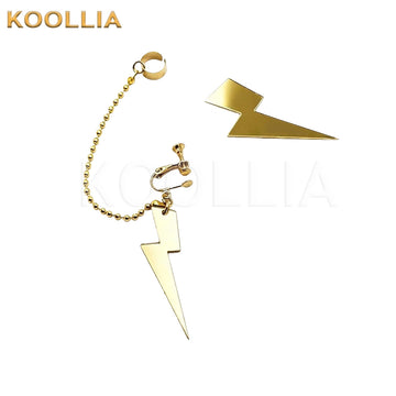 A pair of metallic gold lightning bolt clip-on earrings, with one side featuring a connecting ball chain attached to a matching upper ear cuff.