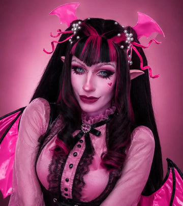 Monster High Draculaura cosplay featuring a premium pink and black pigtail Koollia cosplay wig, styled with vampire wings and a gothic pink outfit.
