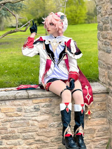 Honkai Star Rail March 7th cosplay costume featuring a detailed white and red outfit, black boots, and a premium short pink Koollia cosplay wig, modeled outdoors.