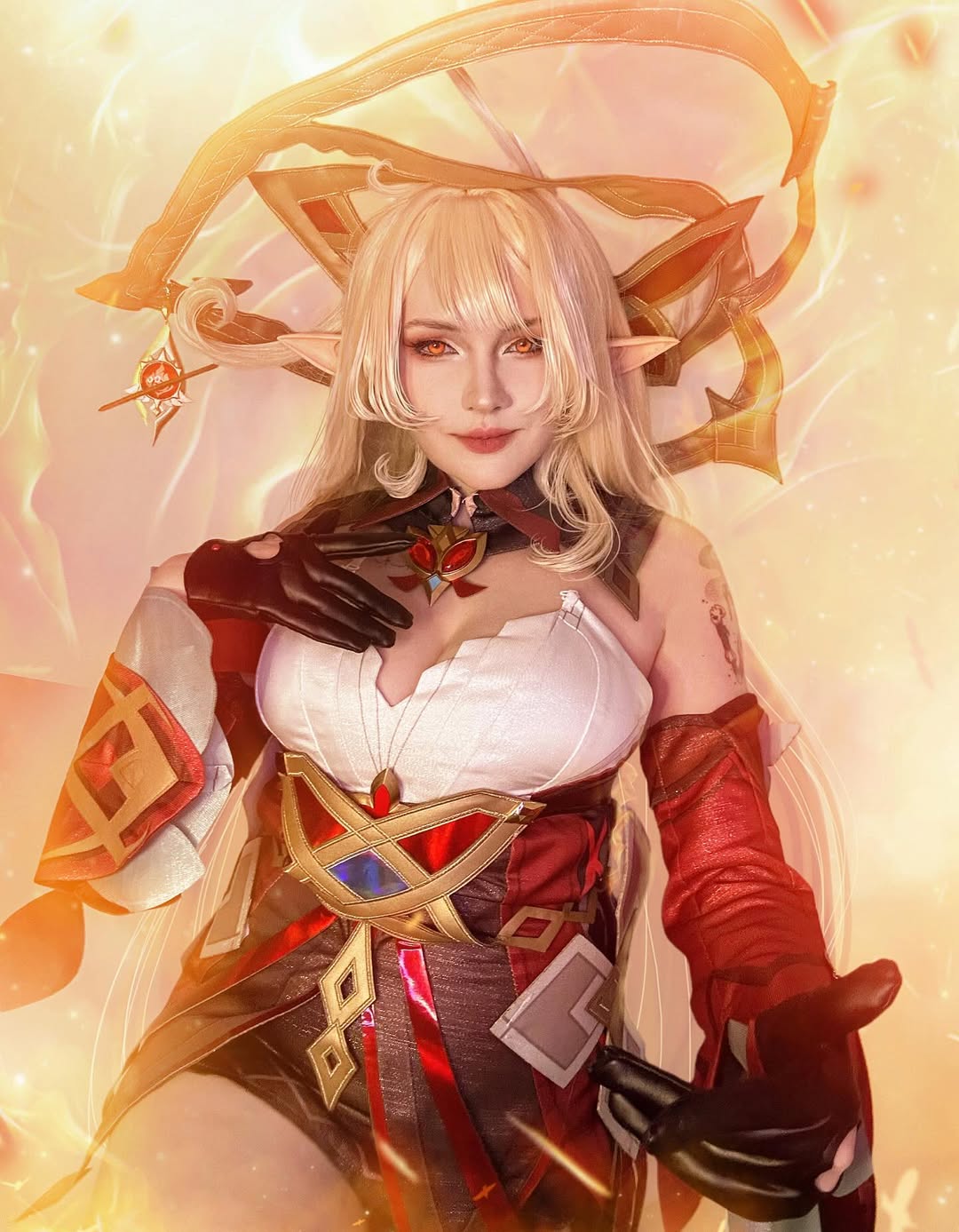 High-quality Genshin Impact Mualani cosplay costume by Koollia, featuring a detailed red and white outfit with blonde elf wig, set against a glowing golden fire background.